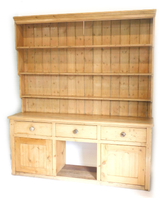 A 19thC pine dresser, the raised back with tapering end supports, the base with three frieze drawers, above two panel doors, flanking a dog kennel on plinth base, 249cm high, 217cm overall.