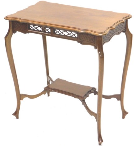 An Edwardian mahogany occasional table, the shaped rectangular top with a blind fret frieze, on cabriole legs with an under tier, 65cm wide.