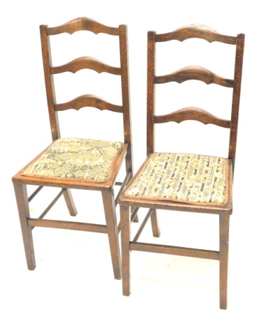 A pair of early 20thC ladderback chairs, 92cm high.