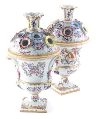 A pair of Samson Paris porcelain urns, each of domed form with stem sections, the shaped bodies, decorated with armorial crest and flowers, predominantly in famille rose colours, faux oriental marks beneath, 32cm high. (2)