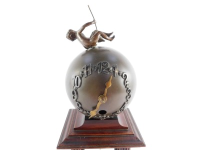 A late 19thC Junghans spelter and brass portico clock, formed as an orb with putto figure and drop pendulum on column base, the orb dial with Arabic numerals, on four brass capped fluted mahogany columns, over a stepped, rectangular base, 31cm high, 12cm - 6