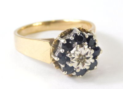 A ladies 9ct gold dress ring, florally claw set with small sapphires centred by a white stone, size N, 4.4g all in. - 3