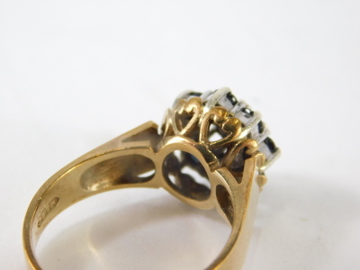 A ladies 9ct gold dress ring, florally claw set with small sapphires centred by a white stone, size N, 4.4g all in. - 4