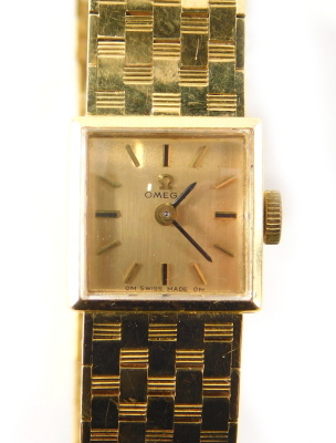 An Omega ladies wristwatch, with 1cm square dial, baton pointers and numerals and textured bracelet marked 18, engraved to the back. - 2