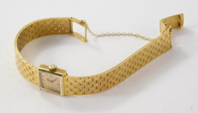 An Omega ladies wristwatch, with 1cm square dial, baton pointers and numerals and textured bracelet marked 18, engraved to the back. - 3