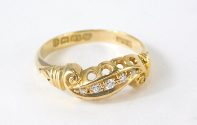 An 18ct gold dress ring, inset with tiny diamonds, 2.4g all in, size M. - 3