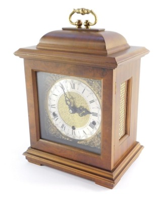 A Schatz walnut cased mantel clock, with square dial having brass spandrels cast as Amorini, chapter ring bearing Roman numerals, eight day movement with Westminster chimes, the case of domed square form, on pad feet, 29cm high, 20cm wide, 14cm deep. - 7