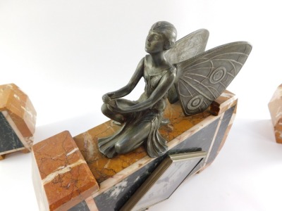 A Continental Art Deco marble cased clock garniture, the rhomboid shaped silvered dial bearing Arabic numerals, thirty hour movement, the case of shaped rectangular form with veined orange and green marble, surmounted with a kneeling figure with butterfly - 8