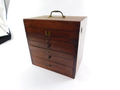 A Victorian mahogany dentist's chest by C Ash Sons & Company Ltd, London, the hinged lid with brass carrying handle, opening to reveal a fitted interior, with ointments and sundries, above five graduated drawers containing various instruments, 35cm high, - 6