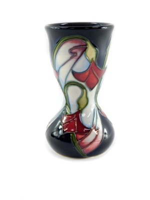 A Moorcroft pottery vase, of waisted form, decorated with delicate red and white flowers against blue ground, second, c2006/08, monogrammed, impressed and painted marks, 11cm high. - 6