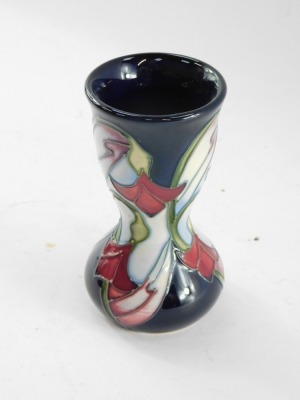 A Moorcroft pottery vase, of waisted form, decorated with delicate red and white flowers against blue ground, second, c2006/08, monogrammed, impressed and painted marks, 11cm high. - 7