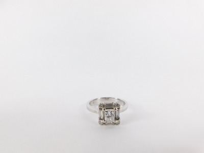 A diamond cluster ring, the central princess cut diamond measuring 4.11mm x 3.98mm x 3.05mm, total estimated carat weight 0.41ct, surrounded by four baguette cut diamonds, each measuring approx 4mm x 1.5mm x 1.8mm, estimated total carat weight 0.30ct, and - 7