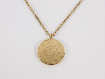 A 9ct gold pendant and chain, the circular floral engraved pendant opening to reveal locket interior, 3cm wide, on a 9ct gold curb link chain, 60cm long, 12.8g all in. - 7