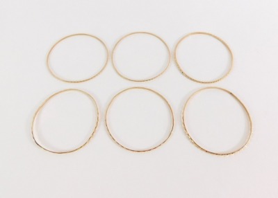 Four Parisian bangles, each of hammered design, yellow metal, unmarked, 28.4g all in, 5cm diameter. - 3