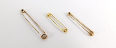 Three gold safety pins, some marked 9ct, 4.9g all in, 5cm, 4cm and 3.5cm. - 3