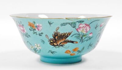 A 19thC Chinese porcelain bowl, the sgraffito turquoise ground incised with repeating scrolls and enamelled with polychromed butterflies, flora and fruits, 22cm diameter, 10cm high. (AF) - 8