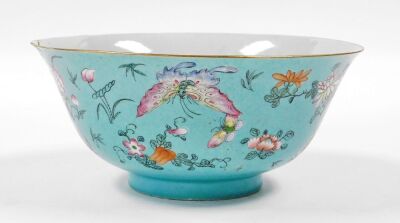 A 19thC Chinese porcelain bowl, the sgraffito turquoise ground incised with repeating scrolls and enamelled with polychromed butterflies, flora and fruits, 22cm diameter, 10cm high. (AF) - 9