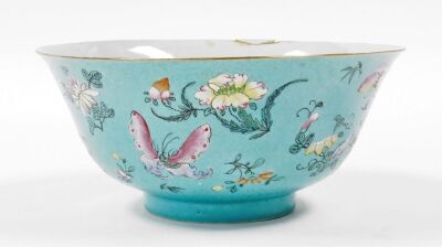 A 19thC Chinese porcelain bowl, the sgraffito turquoise ground incised with repeating scrolls and enamelled with polychromed butterflies, flora and fruits, 22cm diameter, 10cm high. (AF) - 10