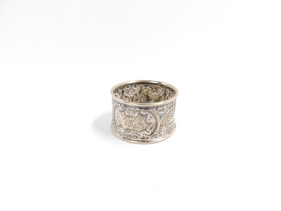 A George V silver napkin ring, with rococo scroll and mask detailing, reserve panel bearing the initials TA, Birmingham 1918, 11.6g all in. - 5