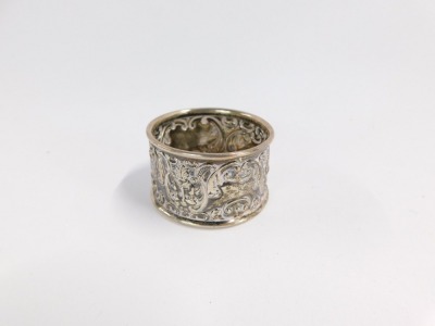 A George V silver napkin ring, with rococo scroll and mask detailing, reserve panel bearing the initials TA, Birmingham 1918, 11.6g all in. - 6