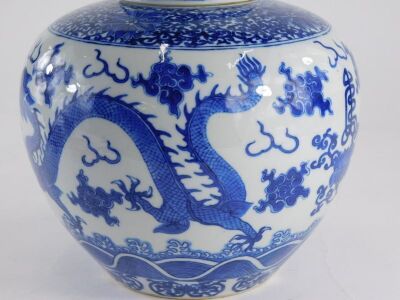 A 19thC Chinese porcelain ginger jar and cover, decorated in underglaze blue with a band of scrolls, peonies above clouds, flowers and four toed dragons, four character Yongzheng mark, 22.5cm high, 22.5cm wide. - 11