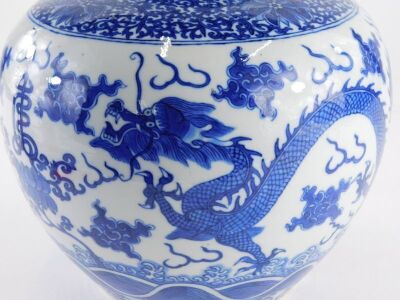 A 19thC Chinese porcelain ginger jar and cover, decorated in underglaze blue with a band of scrolls, peonies above clouds, flowers and four toed dragons, four character Yongzheng mark, 22.5cm high, 22.5cm wide. - 12