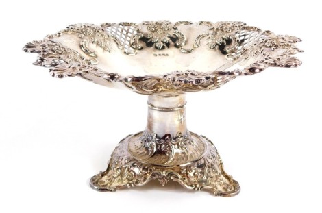 A Victorian silver comport, with hatched and embossed decoration of shells, flowers and rococo scrolls, on a tripod base, Fenton Brothers Ltd, Sheffield 1901, 14¼oz, 13cm high.