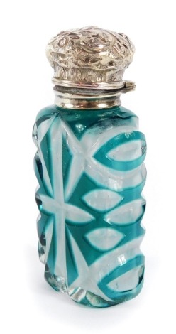 A Victorian flashed glass and silver topped scent bottle, the embossed silver hinged lid, with glass decanter stopper, and cut glass turquoise and clear glass body, hallmark rubbed, 10cm high.