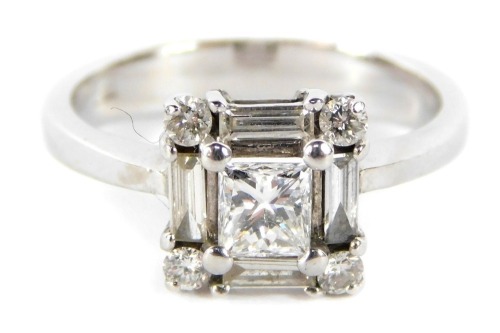 A diamond cluster ring, the central princess cut diamond measuring 4.11mm x 3.98mm x 3.05mm, total estimated carat weight 0.41ct, surrounded by four baguette cut diamonds, each measuring approx 4mm x 1.5mm x 1.8mm, estimated total carat weight 0.30ct, and