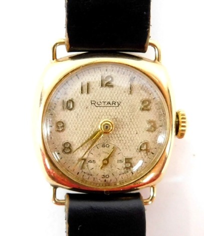 A Rotary 9ct gold lady's wristwatch, with square watch head and circular dial with seconds dial and silvered chequed backing, 2cm wide, on a black leather strap, 13g all in.
