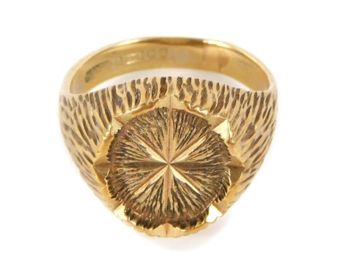 A 9ct gold signet ring, the oval central panel with bark effect detailing on rushed design shoulders, maker HS Limited, Birmingham 1970, ring size T, 8.1g all in.