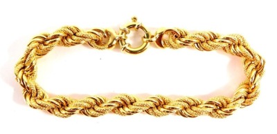 A fancy link bracelet, with layered brushed and plain links, with large circular clasp, yellow metal, marked 750, 19cm long, 18.3g all in.