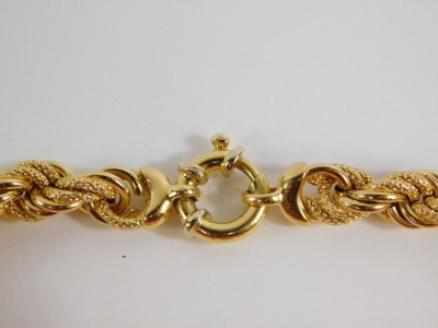 A fancy link bracelet, with layered brushed and plain links, with large circular clasp, yellow metal, marked 750, 19cm long, 18.3g all in. - 2