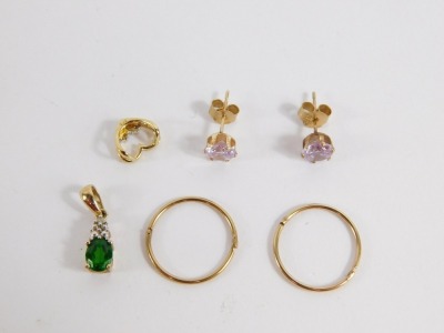 A group of jewellery, comprising a pair of 9ct gold hoop earrings, a pair of paste set stud earrings, a 9ct gold emerald and tear drop pendant and a heart shaped gem set pendant, yellow metal, marked 9kt, 2.9g all in. Note: VAT is payable on the hammer p - 2