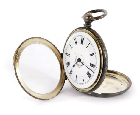 A continental lady's silver pocket watch, open faced, key wind, white enamel dial bearing Roman numerals, with central flower trail detailing, the outer casing with engraved floral and engine turned decoration, vacant shield reserve, with key, 42.2g all i