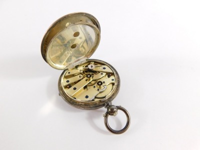 A continental lady's silver pocket watch, open faced, key wind, white enamel dial bearing Roman numerals, with central flower trail detailing, the outer casing with engraved floral and engine turned decoration, vacant shield reserve, with key, 42.2g all i - 3