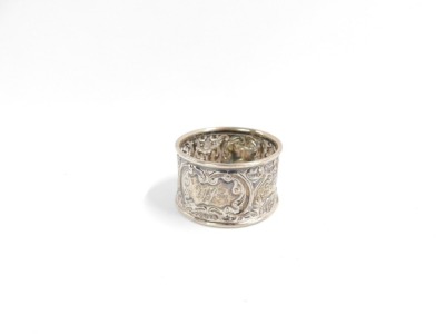 A George V silver napkin ring, with rococo scroll and mask detailing, reserve panel bearing the initials TA, Birmingham 1918, 11.6g all in. - 2