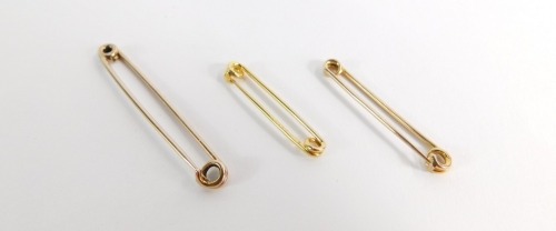 Three gold safety pins, some marked 9ct, 4.9g all in, 5cm, 4cm and 3.5cm.