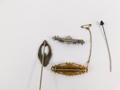 A group of Victorian and later bar brooches, a 9ct gold Victorian C and Co garnet and seed pearl set brooch, with safety chain, 5cm wide, 6g, a Victorian silver buckle bar brooch, 4.5cm wide, and a silver scarf pin, 7cm high, 6.4g, together with a hat pin - 4