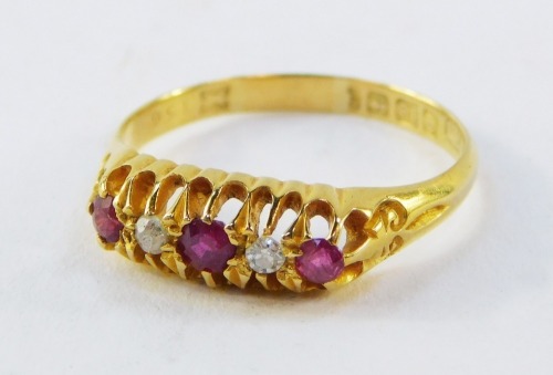 An 18ct gold ruby and diamond ring, the gypsy setting set with three rubies and two diamonds, in claw setting, 2.3g all in.