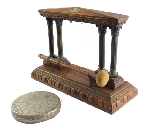 A Victorian oak and brass table gong, of four Corinthian column temple form, on a rectangular base with egg and dart moulding, with clanger, 29cm high, 41cm wide.