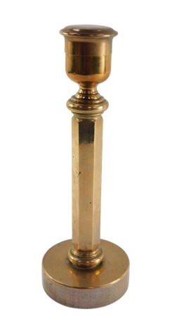 An early 20thC solid brass candlestick, with snuffer lid, 32.5cm high.