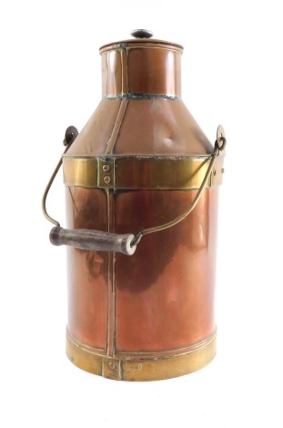 An early 20thC copper and brass bound milk churn, 42cm high.