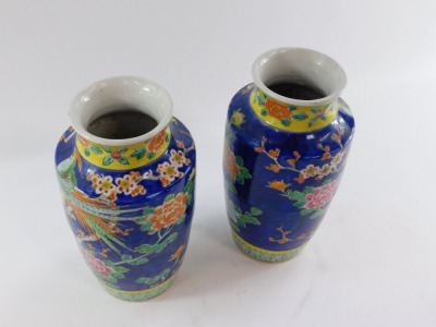 A pair of Japanese mid century porcelain vases, of shouldered ovoid form, decorated with exotic birds, prunus blossom and flowers against a cobalt blue ground, 35cm high. - 5