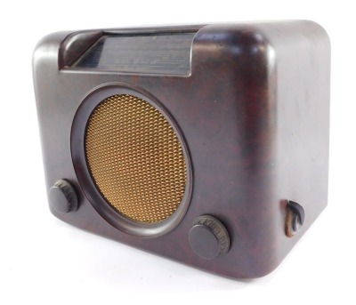 A Bush vintage radio, in a mottled brown Bakelite case, with gold finish grill, type DAC 90A, 25cm high, 29cm wide, 19cm deep.