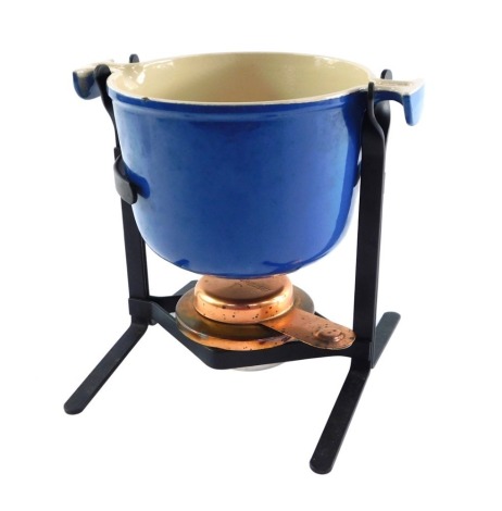 A Le Crueset blue enamel fondue stove, with a cast iron stand and copper burner.