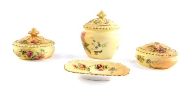 A Royal Worcester blush porcelain part dressing table set, c1911, painted with meadow flowers, printed marks, comprising three circular jars and covers and a pin dish. (4, AF)