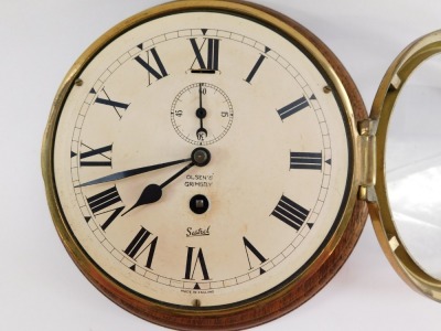 A Sestrel early 20thC brass cased ships porthole clock, for Olsen's of Grimsby, circular dial bearing Roman numerals, subsidiary seconds dial, with key, 23cm diameter. - 2