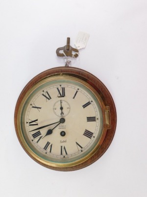 A Sestrel early 20thC brass cased ships porthole clock, for Olsen's of Grimsby, circular dial bearing Roman numerals, subsidiary seconds dial, with key, 23cm diameter. - 3