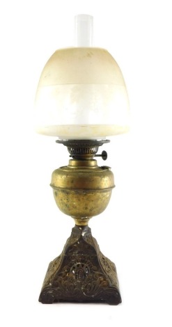 A Duplex brass and cast oil lamp, with an Art Nouveau floral base, brass reservoir, glass chimney, and clear and etched glass shade decorated with a band of vines. 50cm high.